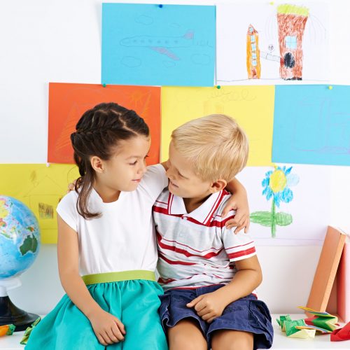 Portrait of little boy and girl embracing