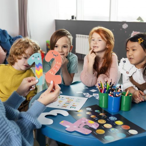 medium-shot-kids-sitting-together-table-min